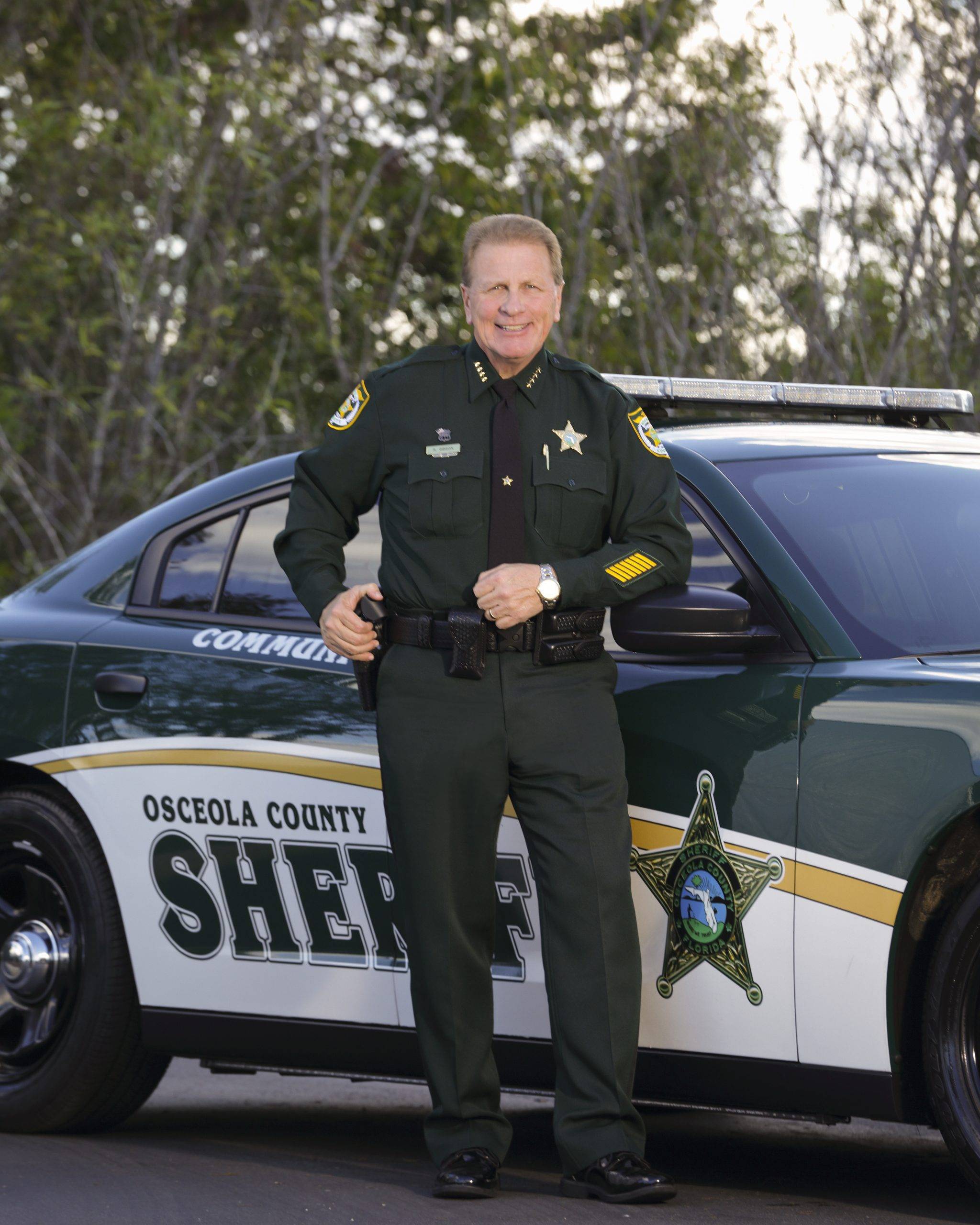 Sheriff Gibson next to patrol car
